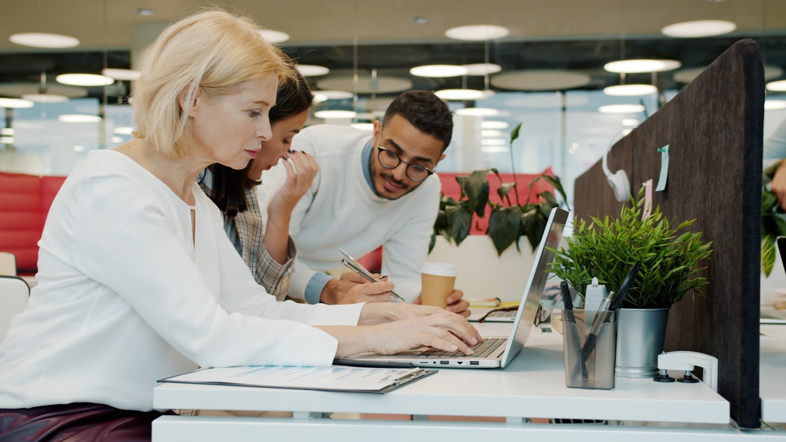 Marketing team reviewing a laptop while planning a growth strategy