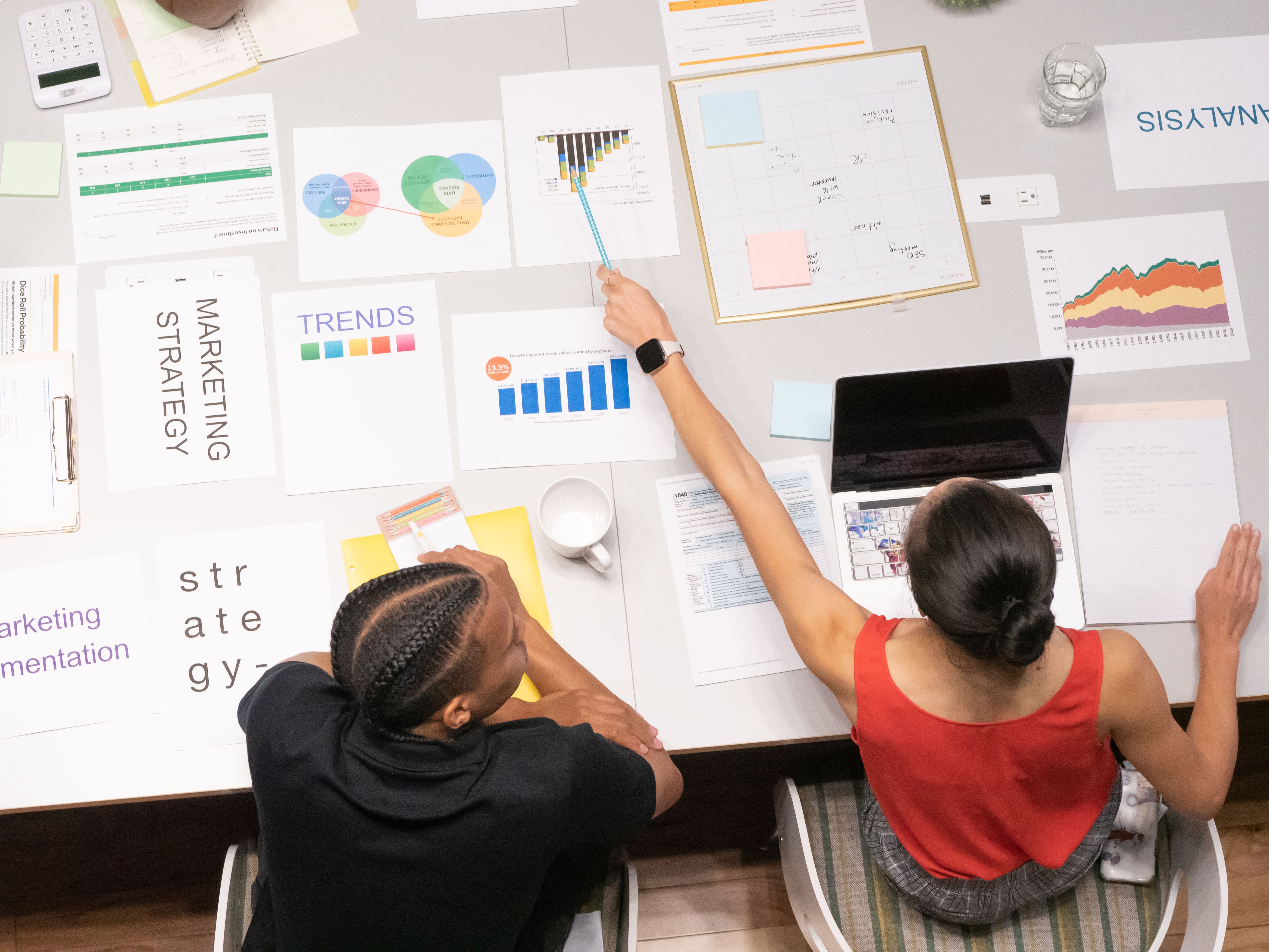 Marketing strategy documents, charts and planning materials on an office table